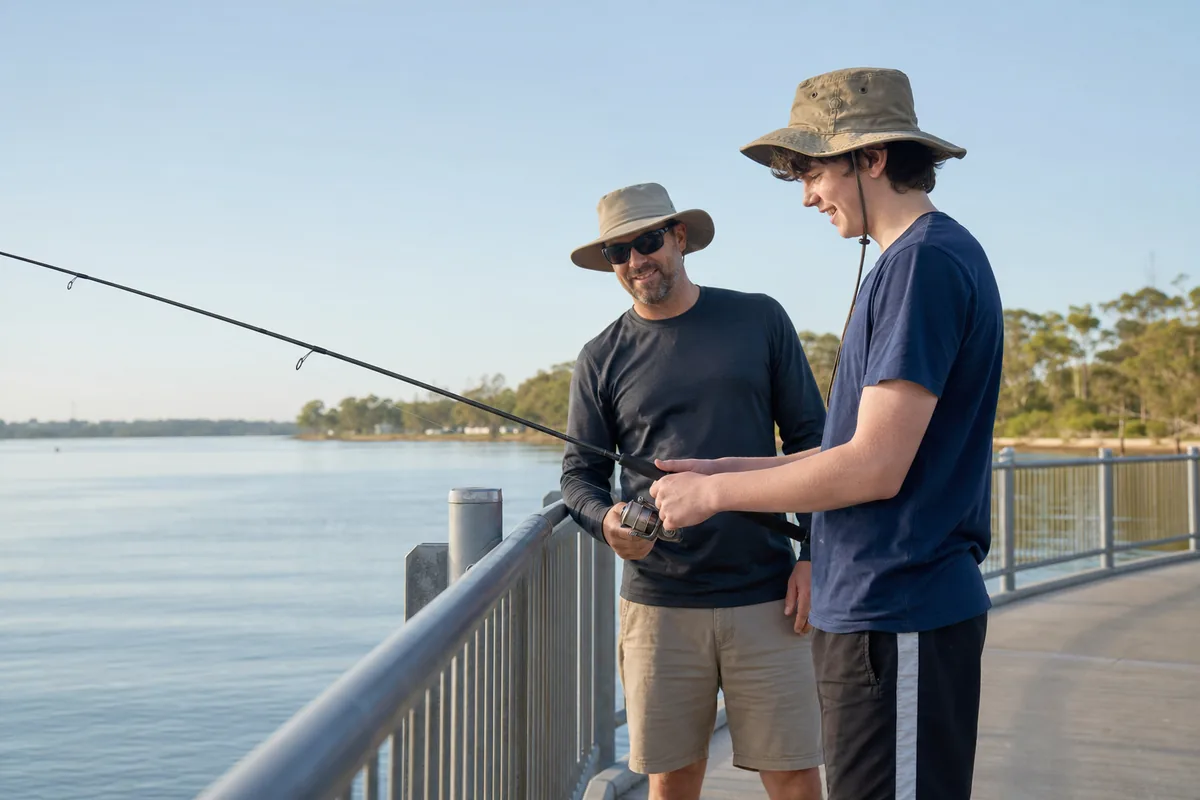 Teenage participant enjoying supported fishing from an accessible Perth jetty