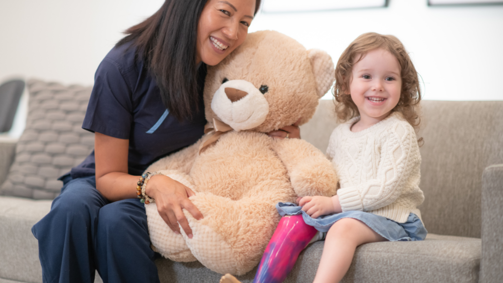 A smiling NDIS participant reviewing their budget plan with a support worker in a comfortable home setting, symbolizing empowerment and independence.